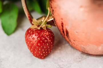 Red ripe strawberry on the rustic background. Selective focus.