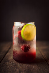 Refreshing summer cocktail with cherries and rum on the rustic background. Selective focus.
