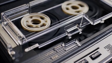 nostalgic looped animation of cassette tapes rewinding and fast forwarding inside a retro deck player symbolizing the golden era of analog music and iconic sound recording formats of the past