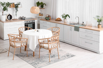 Interior of kitchen with white counters and dining table