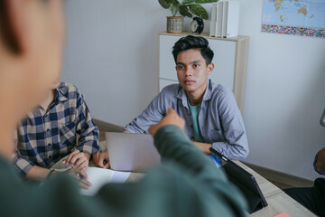 Focused Student Receiving Guidance From Colleague During Study Session