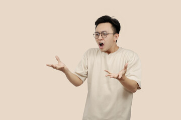 Frustrated young asian Man Expressing Anger With Aggressive Gesture in Casual Attire