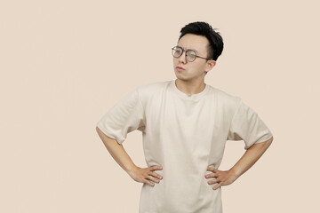 Frustrated young asian Man Expressing Anger With Aggressive Gesture in Casual Attire