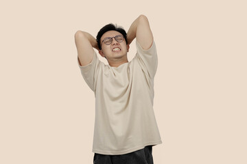Frustrated young asian Man Expressing Anger With Aggressive Gesture in Casual Attire