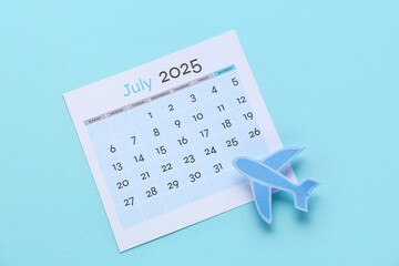 Calendar with plane on blue background. Summer vacation concept