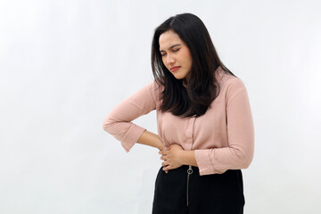 Asian woman holding stomach, suffering from stomach ache on right side, acute pain, closing eyes,...