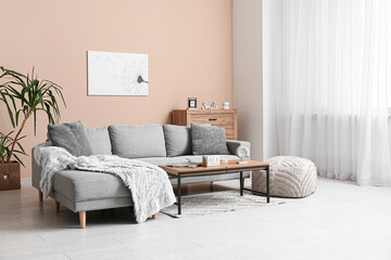 Interior of living room with sofa and cube calendar on table