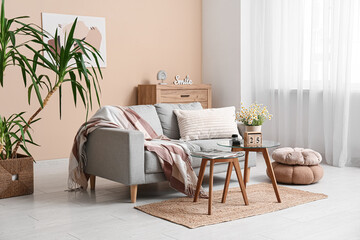 Interior of living room with sofa, tables and cube calendar