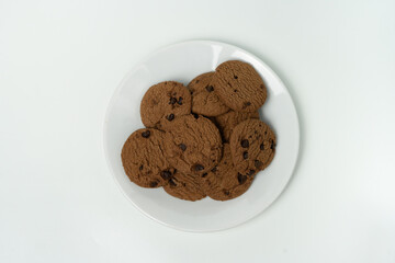 Pile of Delicious Chocolate Cookies with Chocolate Chips on White Background
