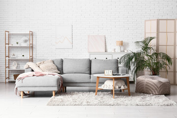 Interior of living room with sofa and cube calendar on table
