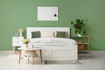 Interior of bedroom with tables and shelf unit