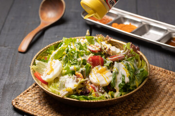 Korean-Style Salad with Fresh Vegetables and Sesame Dressing – Healthy Mixed Salad with Korean Flavors, Featuring Lettuce, Perilla Leaves, Carrot, Cabbage and Seasoned Soy-based Sauce
