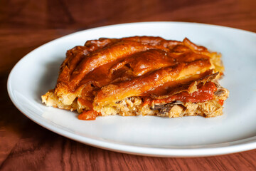 Tuna empanada on a white plate. Concept of empanada gallega
