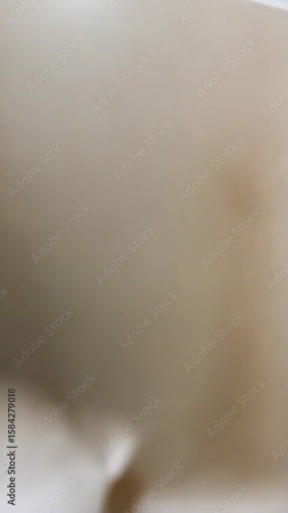 Poster abstract video of subtle light and shadow playing on a softly crumpled and folded creamy white fabri