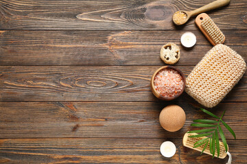 Obraz na płótnie Canvas Beautiful spa composition with bowl of sea salt and bath supplies on brown wooden background