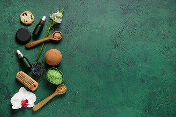 Beautiful spa composition with bath supplies, bowl and spoons of sea salt on green grunge background