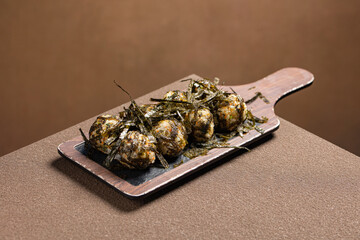 Traditional Korean rice balls (Jumeokbap) coated with roasted seaweed flakes. Hand-shaped bite-sized rice snacks served as simple Korean side dish, lunchbox item, or light savory meal.  © Blake Lee