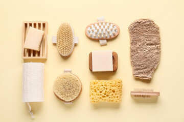 Composition with massage body brushes, soap bars and sponges on beige background, closeup