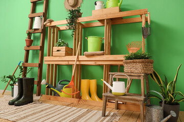Interior of workshop with gardening tools, shelf unit and ladder