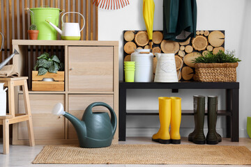 Interior of workshop with gardening tools, plants and stand