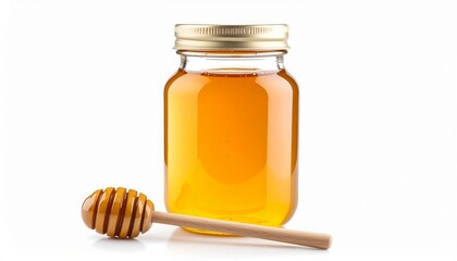 Honey in a glass jar with a wooden dipper on a white background.