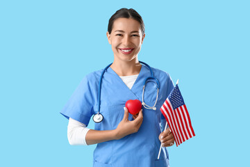Female doctor with heart and USA flag on blue background. Labor Day celebration