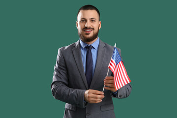 Young businessman with USA flag on green background. Labor Day celebration
