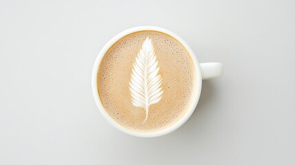 Overhead view of a white coffee cup with delicate leaf latte art