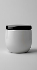This is a ceramic jar with a sleek black lid, showcasing a minimalist design and smooth, clean lines.