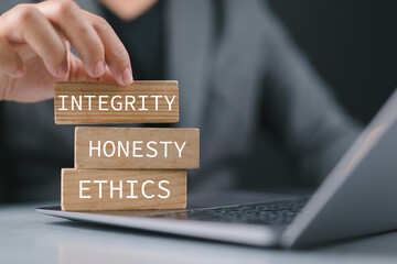 Integrity honesty ethics symbol. Businessman holding wood words Integrity honesty ethics. Business...