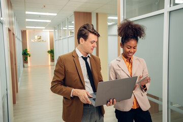 Two happy business woman and man using laptop working on computer