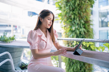 Shot of elegant business woman smiling and using tablet.