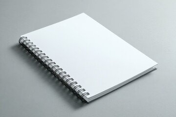 Blank spiral-bound notebook on gray surface (1)