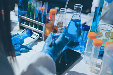Scientist pipetting medical samples into microplate in laboratory