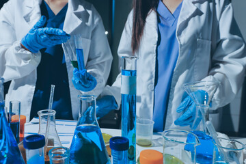 Scientist pipetting medical samples into microplate in laboratory
