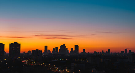 Fototapeta premium Cityscape silhouette at twilight under a vibrant gradient sky creating urban beauty