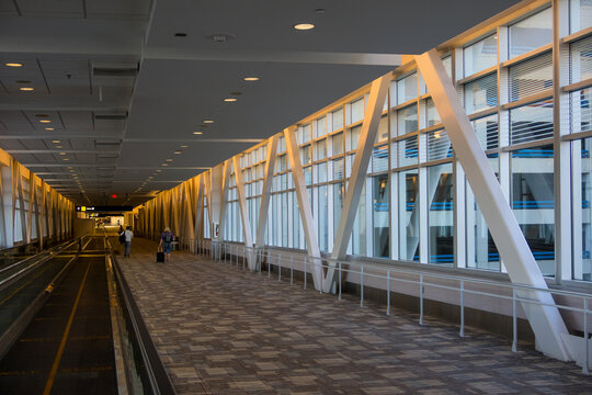 Interior view of Minniapolis International airport airport wide open corridor during off peak hour.