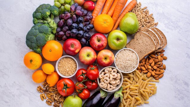 A vibrant assortment of fresh fruits vegetables grains nuts and pasta arranged on a textured surface