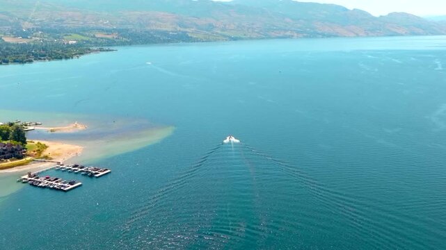 Wake boat surf boat driving sunny day aerial drone slow motion
