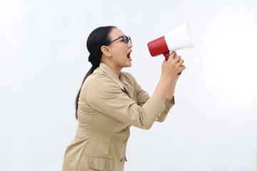 Beautiful Asian civil servant woman talking on megaphone to sideways isolated on white background
