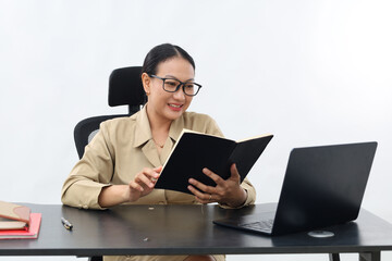 Attractive satisfied young Asian civil servant woman in formal working at his desk in the white...