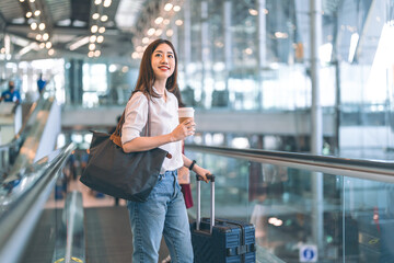 Adult passenger business asian woman with coffee cup and luggage at airport terminal for depature