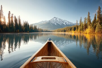 Tranquil Canoe Ride on Lake with Stunning Mountain Views and Evergreen Forest Reflections at Sunrise