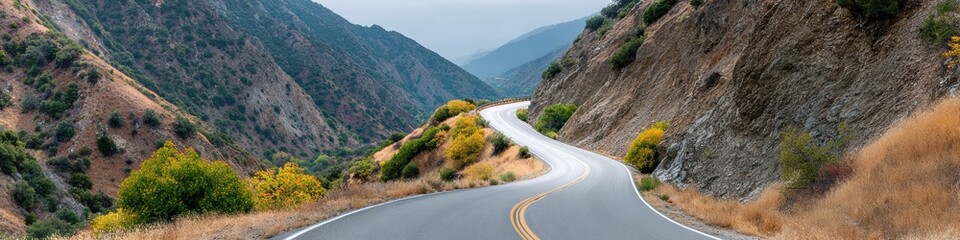 Naklejka premium Premium Authentic Mountain Switchback Road with Sharp Hairpin Turns in Rugged Landscape for Adventure Travel Marketing and Inspiring Outdoor Social Media Campaigns