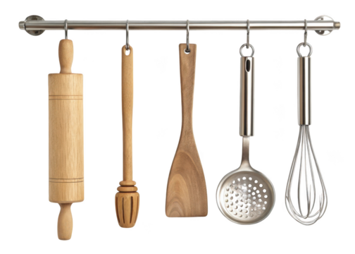 Collection of kitchen utensils including a rolling pin whisk and spatula hanging on a rack isolated on transparent background