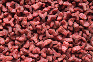 Red Granulated Dry Pet Food. Texture of cat and dog food.
