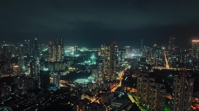 A hyperlapse aerial shot of Mumbai city at night, showcasing the dynamic cityscape illuminated with vibrant lights. Perfect for themes of finance, technology, infrastructure, metropolitan lifestyle.