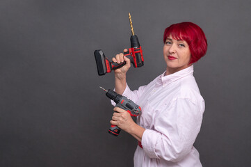 Professional-grade power tools in woman's hands symbolize gender equality in construction....