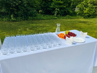 A beautifully arranged table featuring an abundance of elegant wine glasses alongside a delightful...