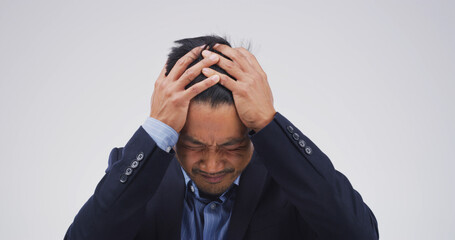 Stress, headache and business man in studio for debt crisis, emergency and stock market crash....